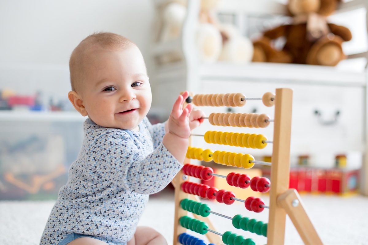 baby playing with an abacus at home