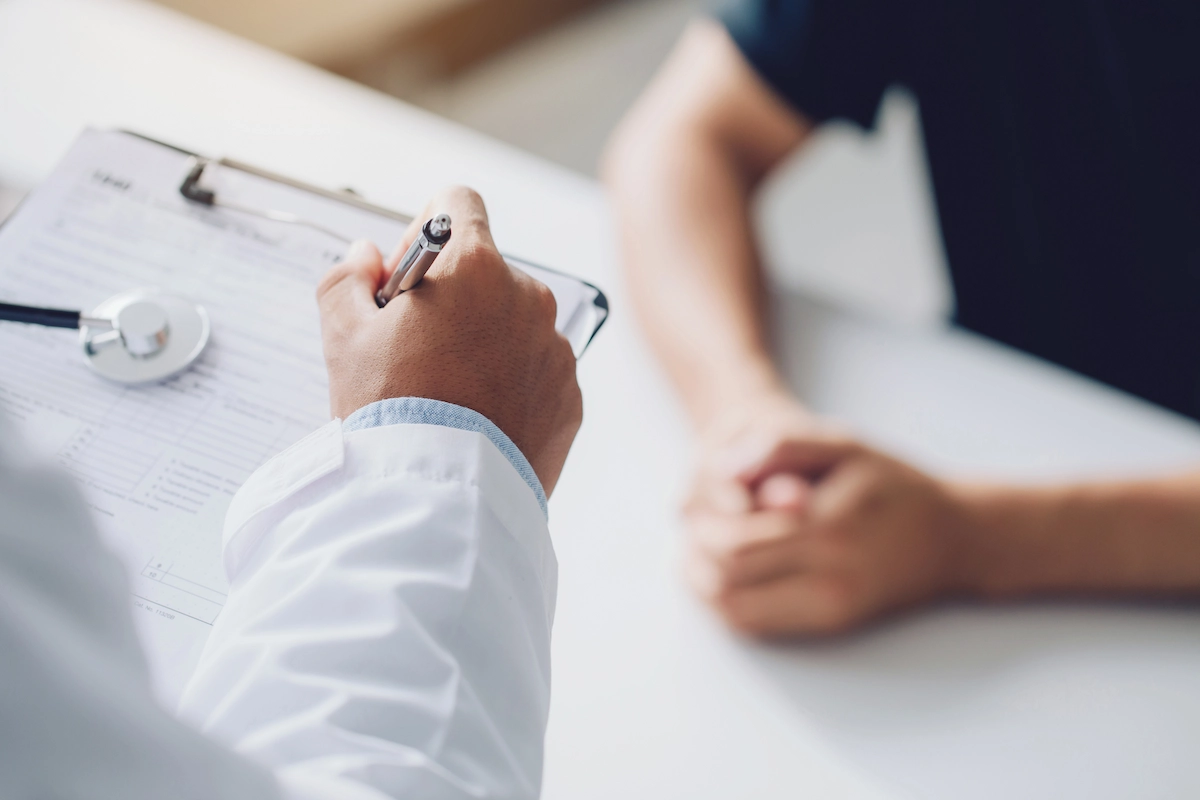 Doctor reviewing health chart with patient